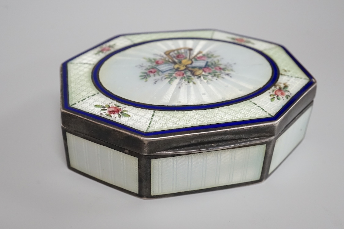 An Edwardian silver and guilloche enamel octagonal box with hinged cover, import marks for Erich Kellerman, London, 1909, decorated with flowers and musical instruments, 77mm.